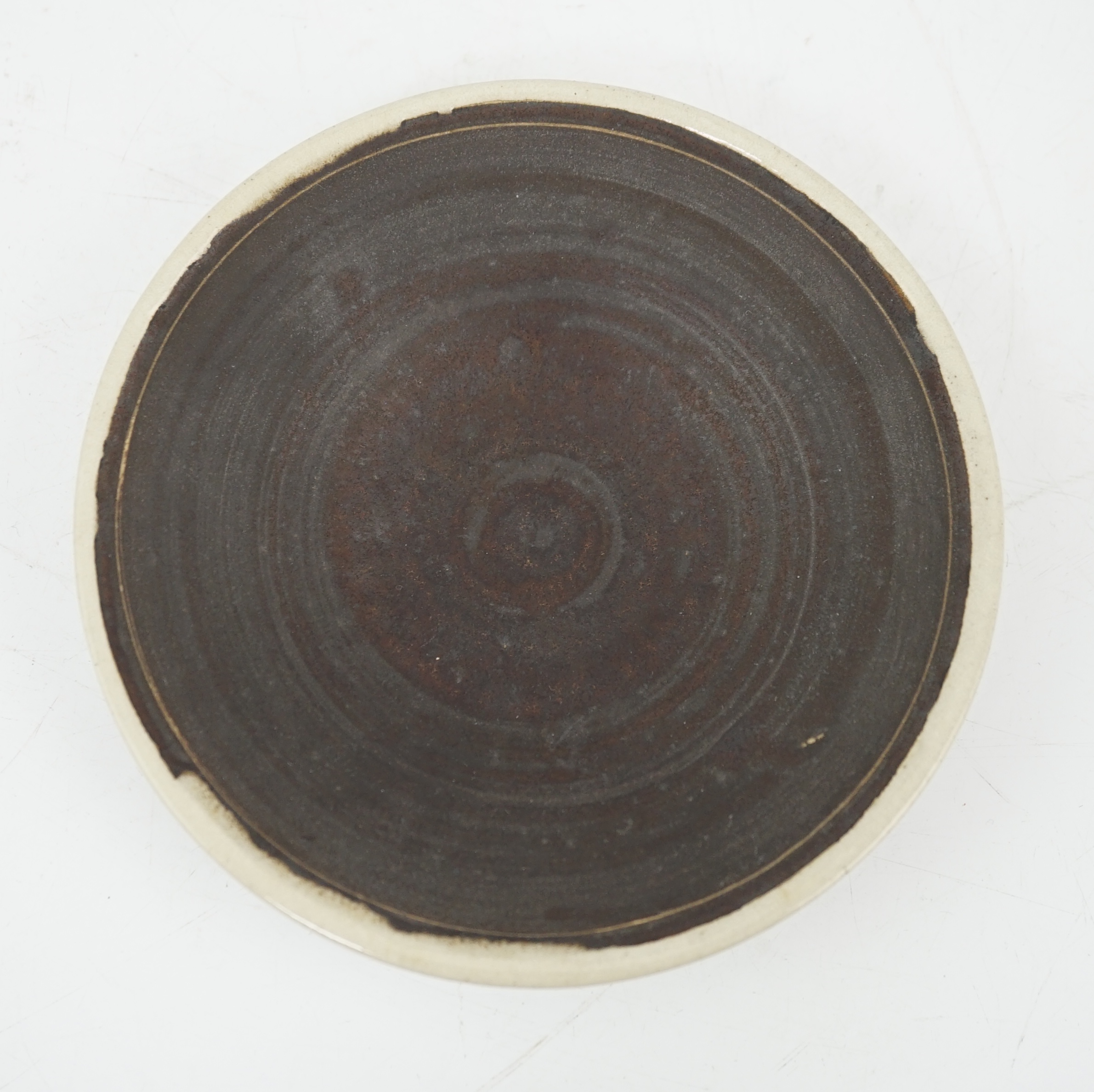 Dame Lucie Rie D.B.E. (1902-1995), a manganese glazed coffee cup and saucer